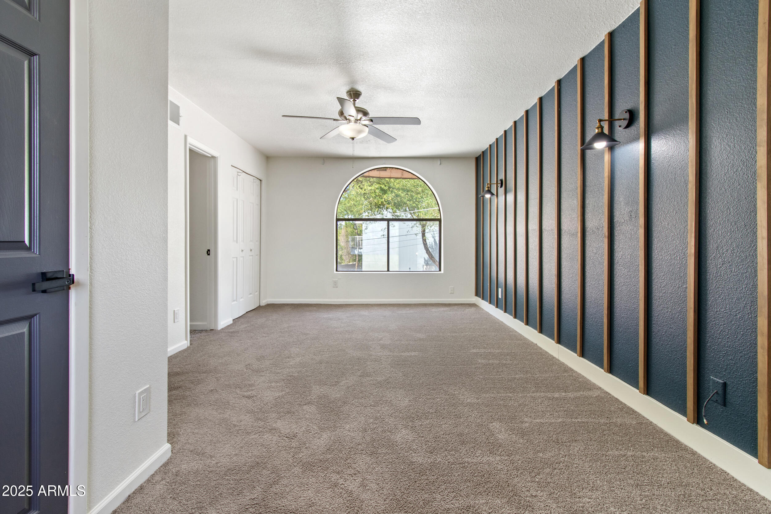 2500 North Hayden Road, Unit 15 Scottsdale, AZ 85257 - Photo 14 of 34 an empty room with windows and chandelier fan