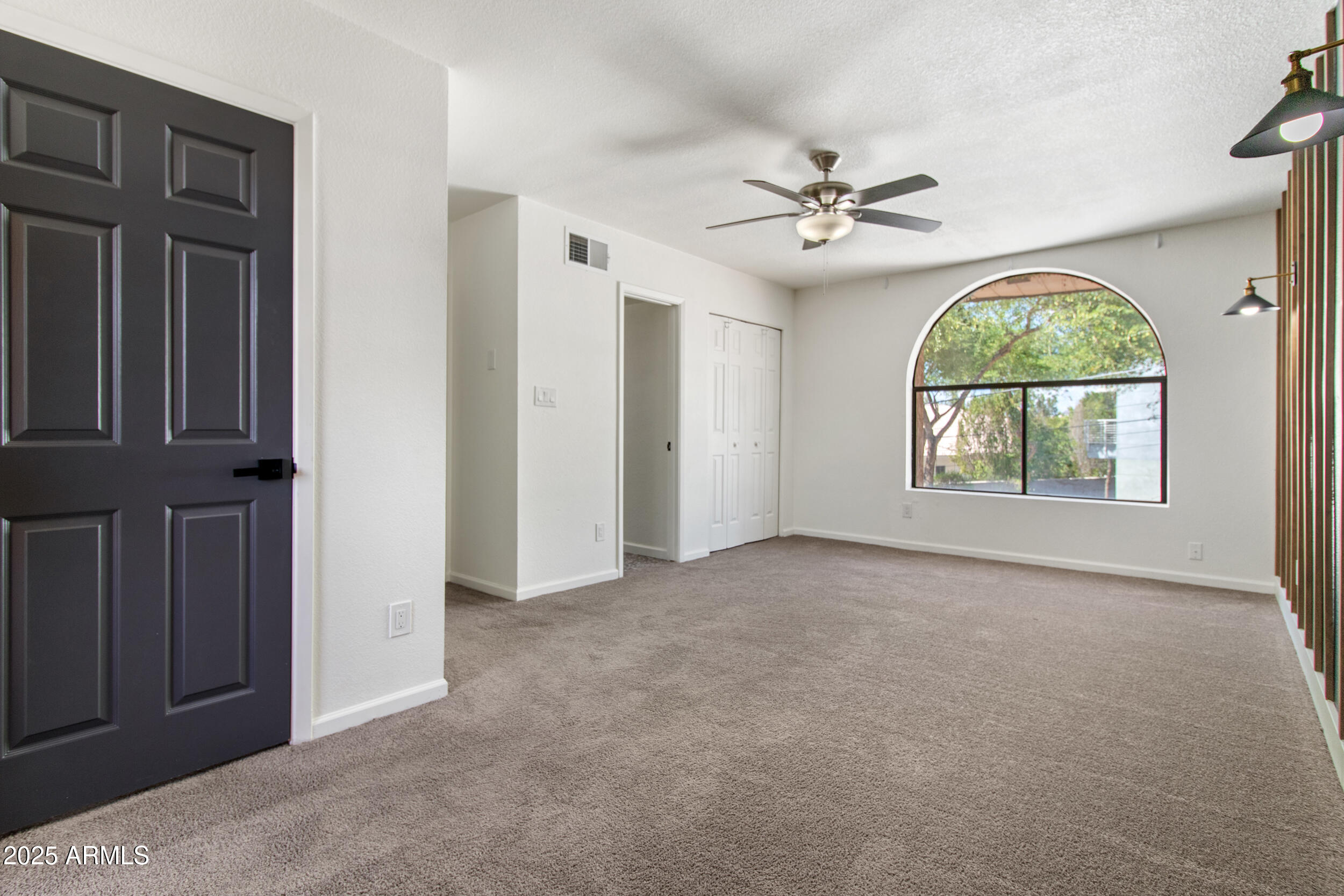 2500 North Hayden Road, Unit 15 Scottsdale, AZ 85257 - Photo 15 of 34 an empty room with windows and fan