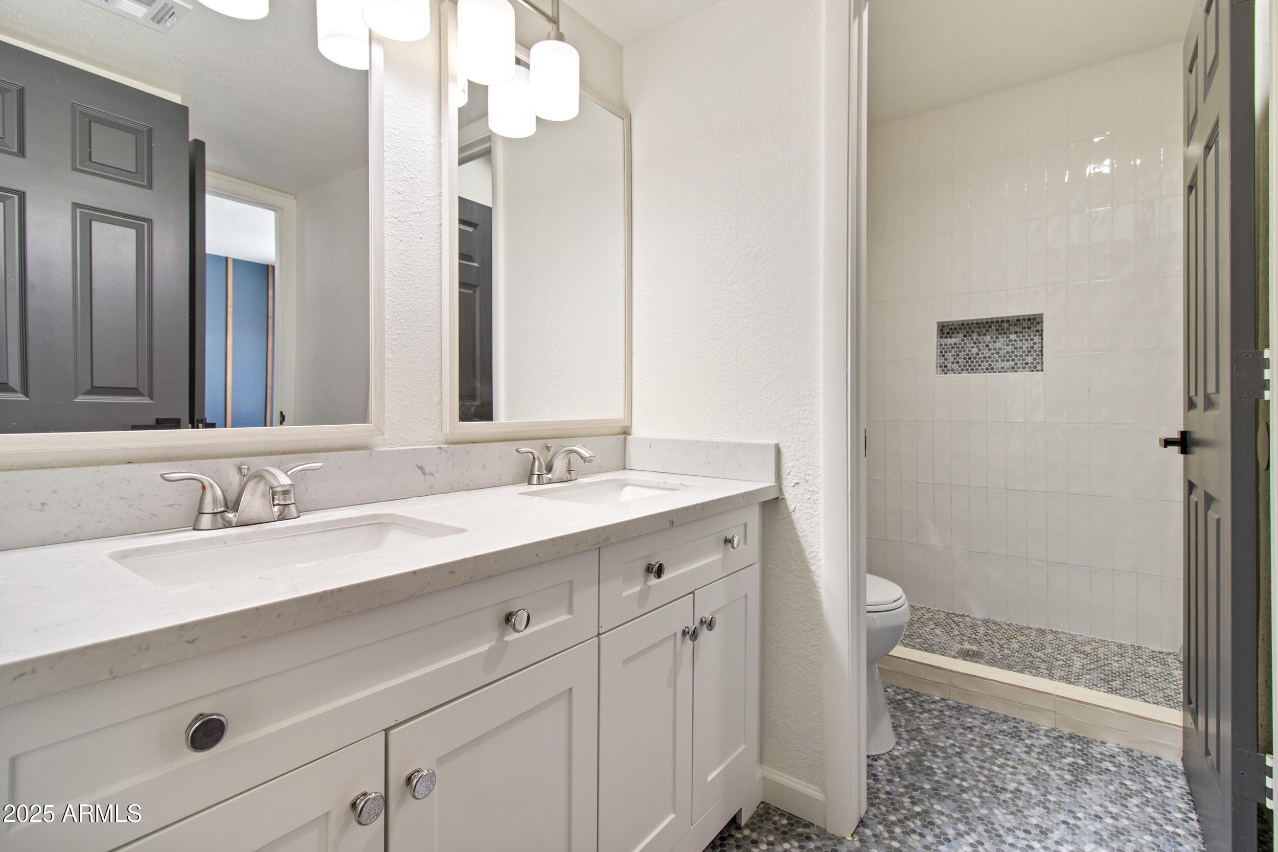 2500 North Hayden Road, Unit 15 Scottsdale, AZ 85257 - Photo 20 of 34 a bathroom with a double vanity sink a toilet and a mirror