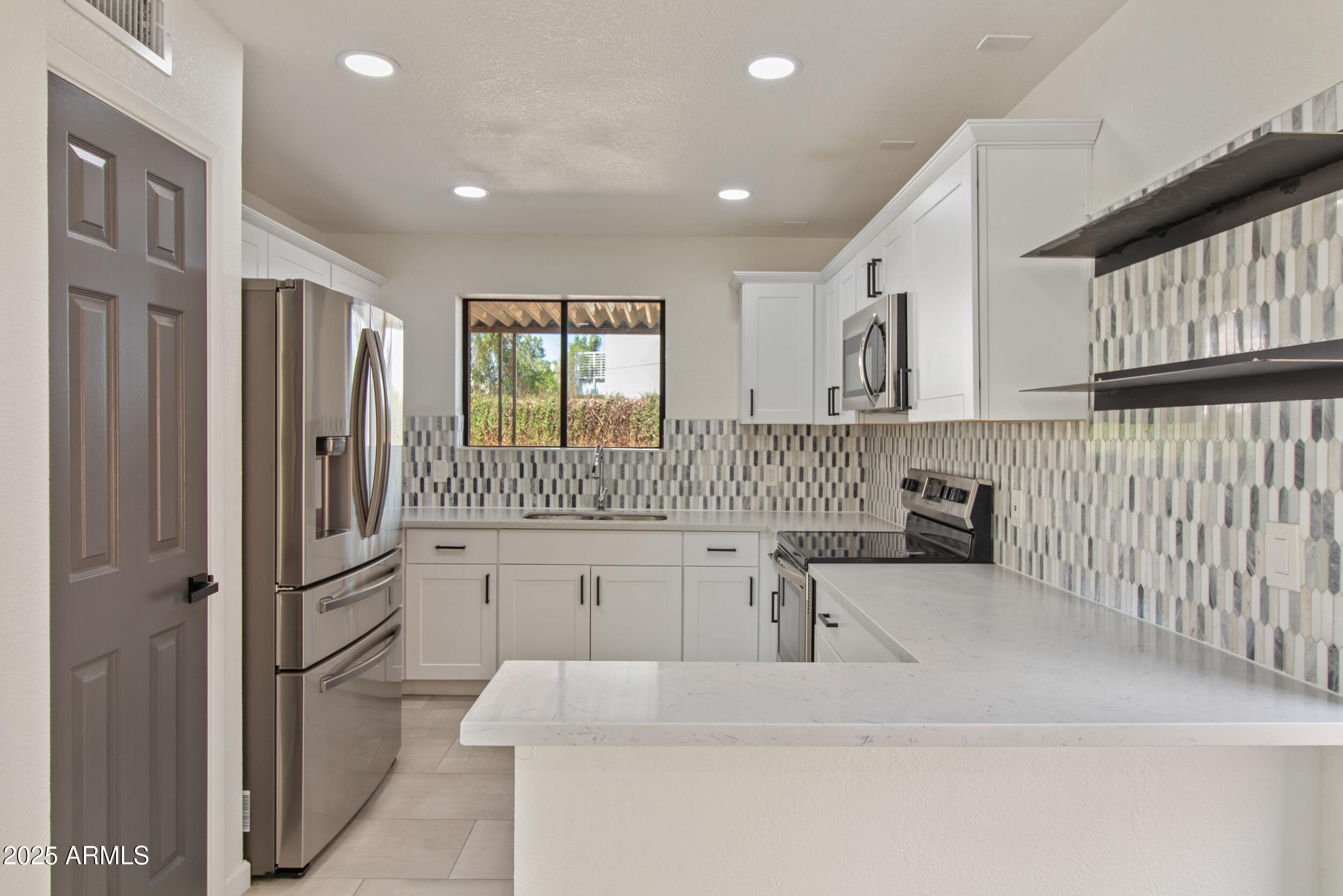 2500 North Hayden Road, Unit 15 Scottsdale, AZ 85257 - Photo 9 of 34 a kitchen with white cabinets and refrigerator