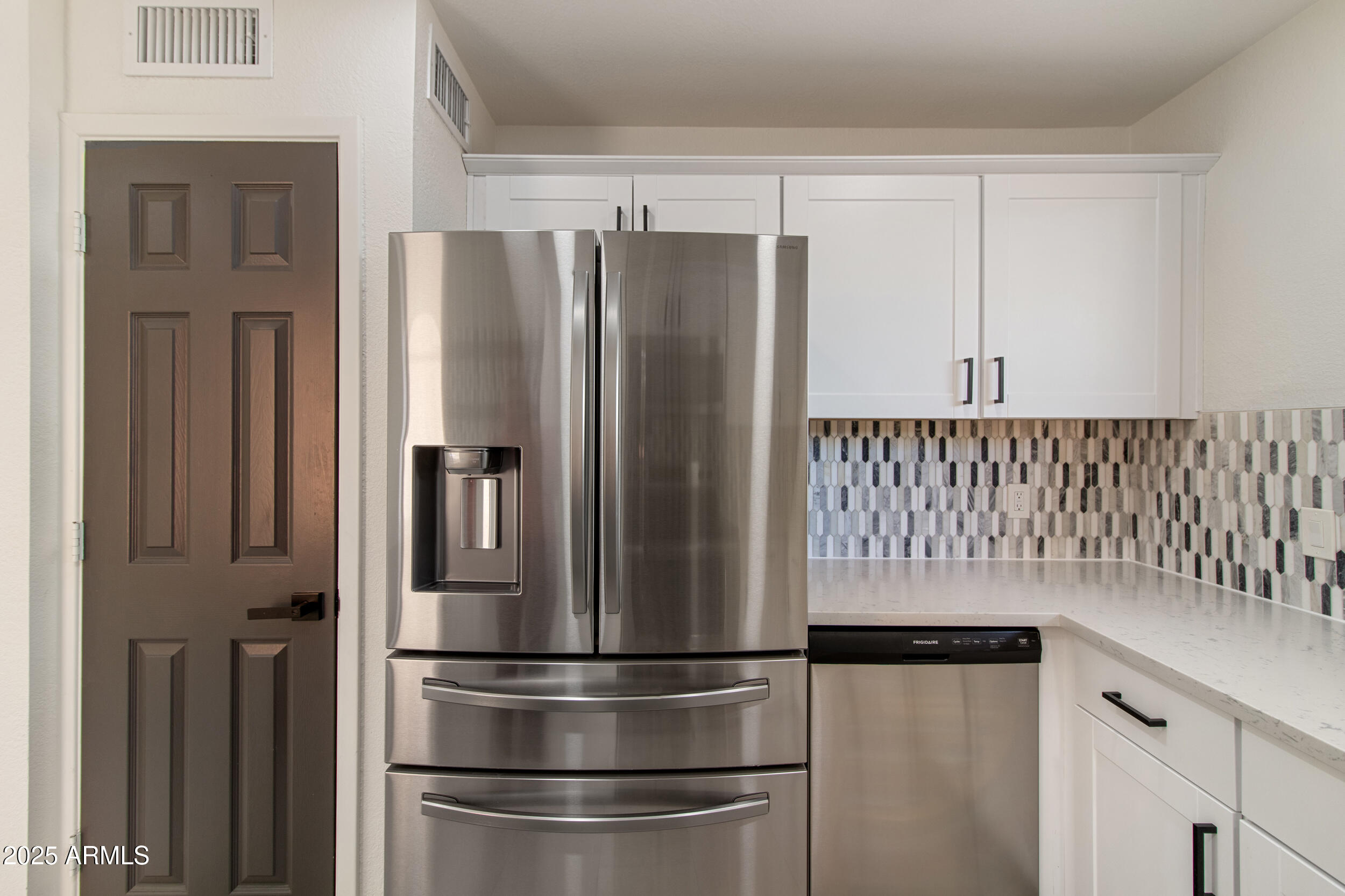 2500 North Hayden Road, Unit 15 Scottsdale, AZ 85257 - Photo 10 of 34 a kitchen with metallic refrigerator freezer and a dishwasher