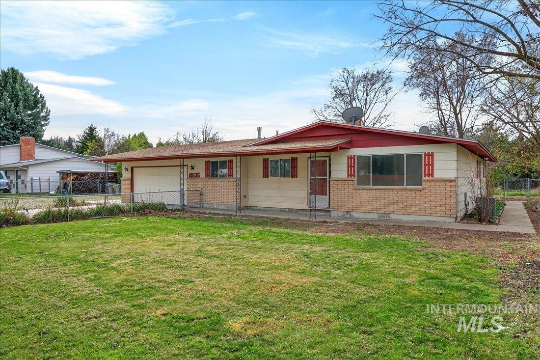 Single story home featuring brick siding and an attached garage