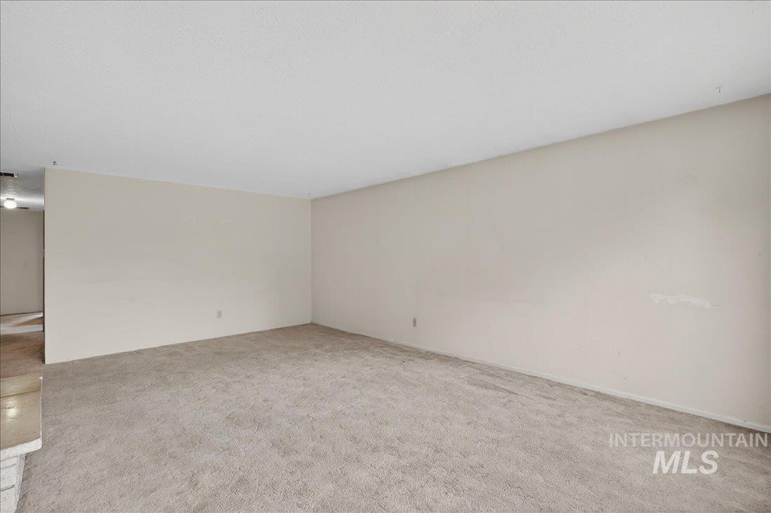 10035 W Lane Boise, ID 83709 - Photo 12 of 32 Empty room featuring light carpet