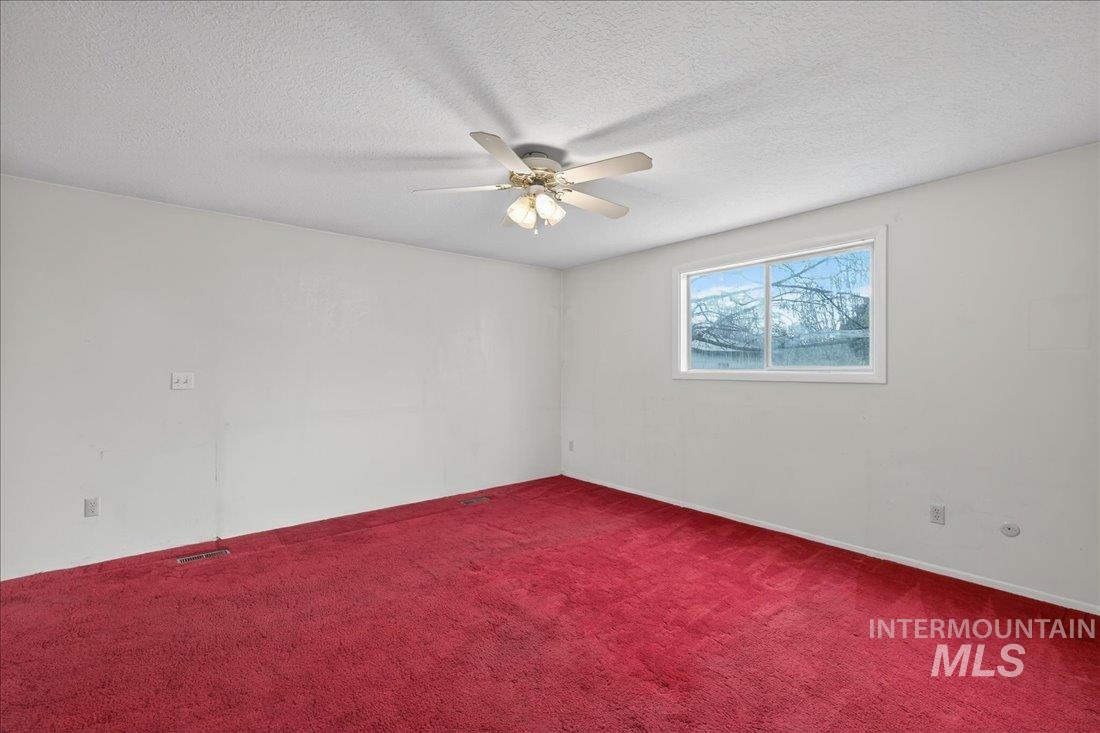 10035 W Lane Boise, ID 83709 - Photo 19 of 32 Carpeted empty room with a textured ceiling and a ceiling fan