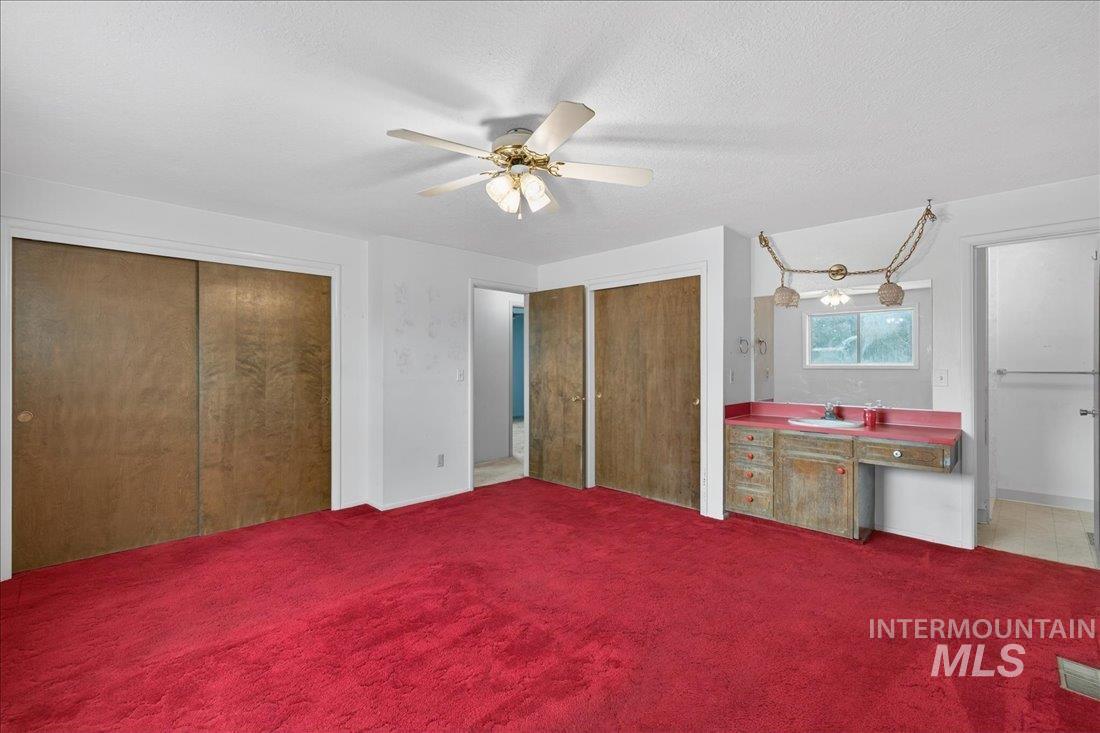 10035 W Lane Boise, ID 83709 - Photo 20 of 32 Unfurnished bedroom with carpet, a textured ceiling, and a ceiling fan