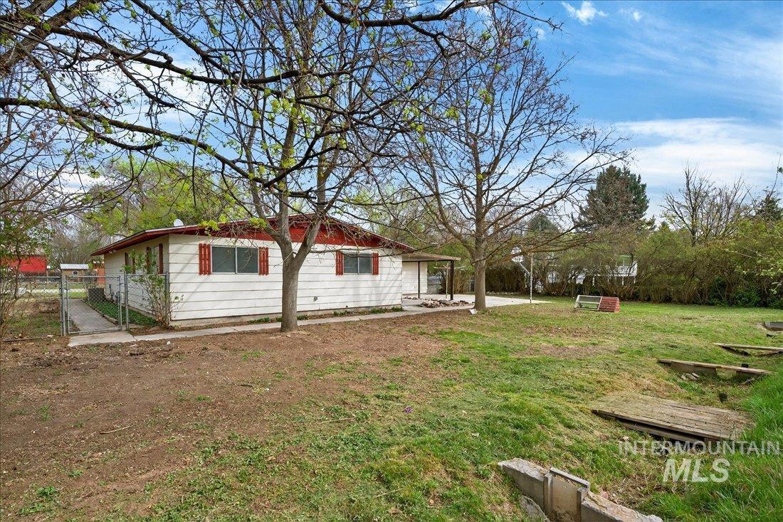 10035 W Lane Boise, ID 83709 - Photo 2 of 32 Back of property featuring a gate and a yard