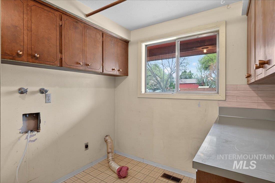 10035 W Lane Boise, ID 83709 - Photo 23 of 32 Laundry area with hookup for a washing machine, cabinet space, and hookup for an electric dryer