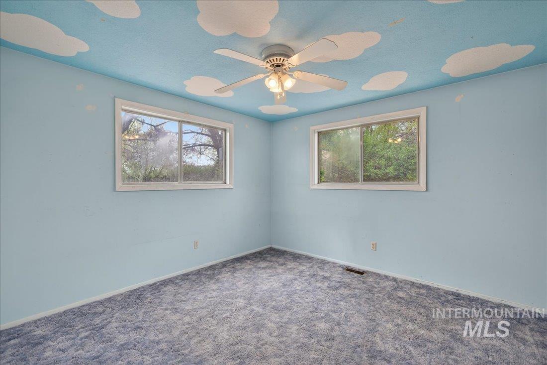 10035 W Lane Boise, ID 83709 - Photo 24 of 32 Carpeted spare room featuring plenty of natural light and ceiling fan