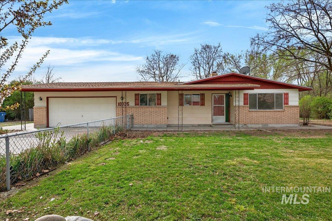 10035 W Lane Boise, ID 83709 - Photo 3 of 32 Ranch-style house with brick siding, a garage, and a front lawn