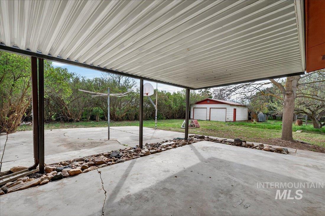10035 W Lane Boise, ID 83709 - Photo 5 of 32 View of patio featuring an outbuilding and a garage