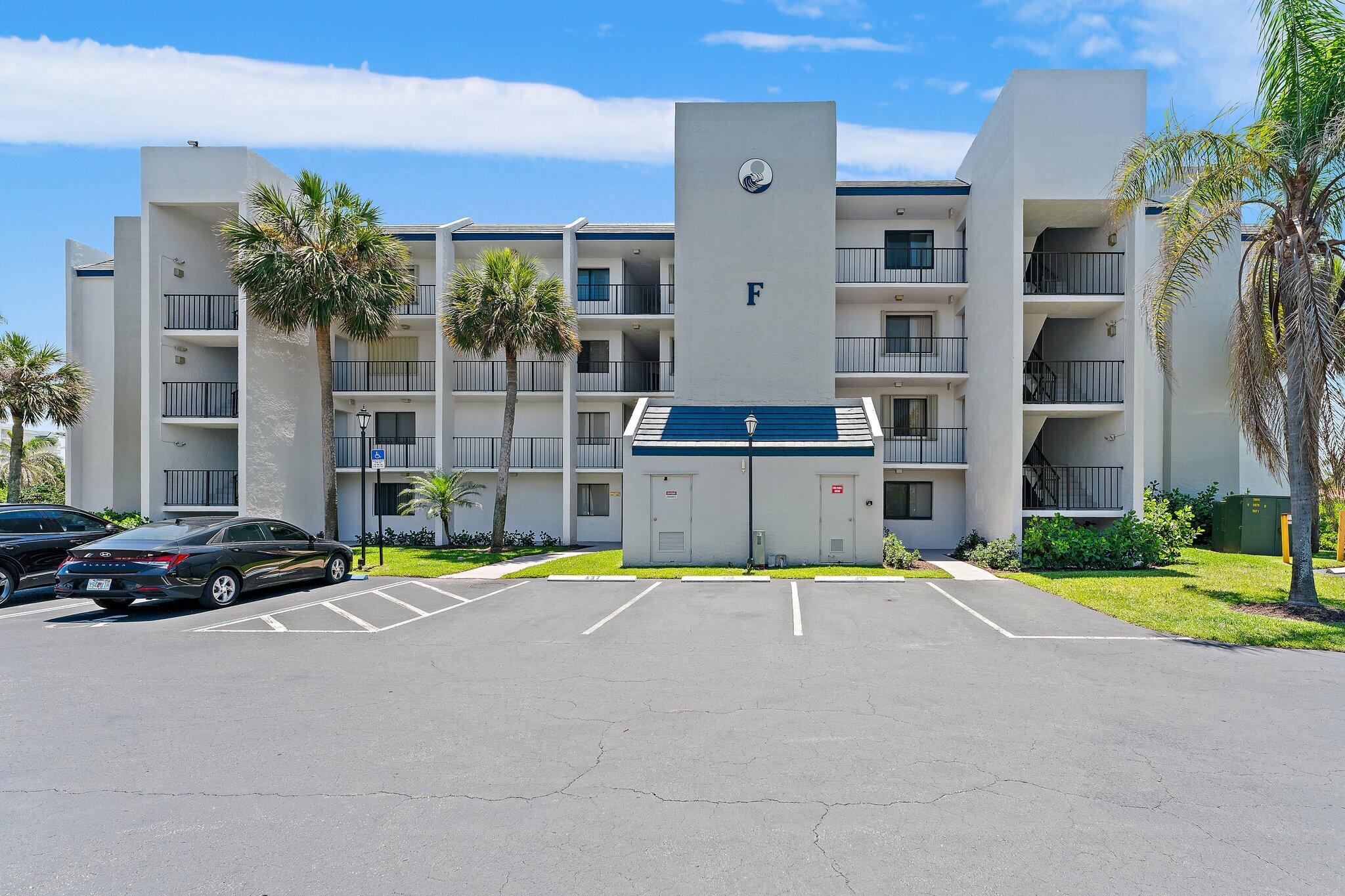 1605 South U Highway, Unit F 106 Jupiter, FL 33477 - Photo 19 of 43 a car parked in front of a building