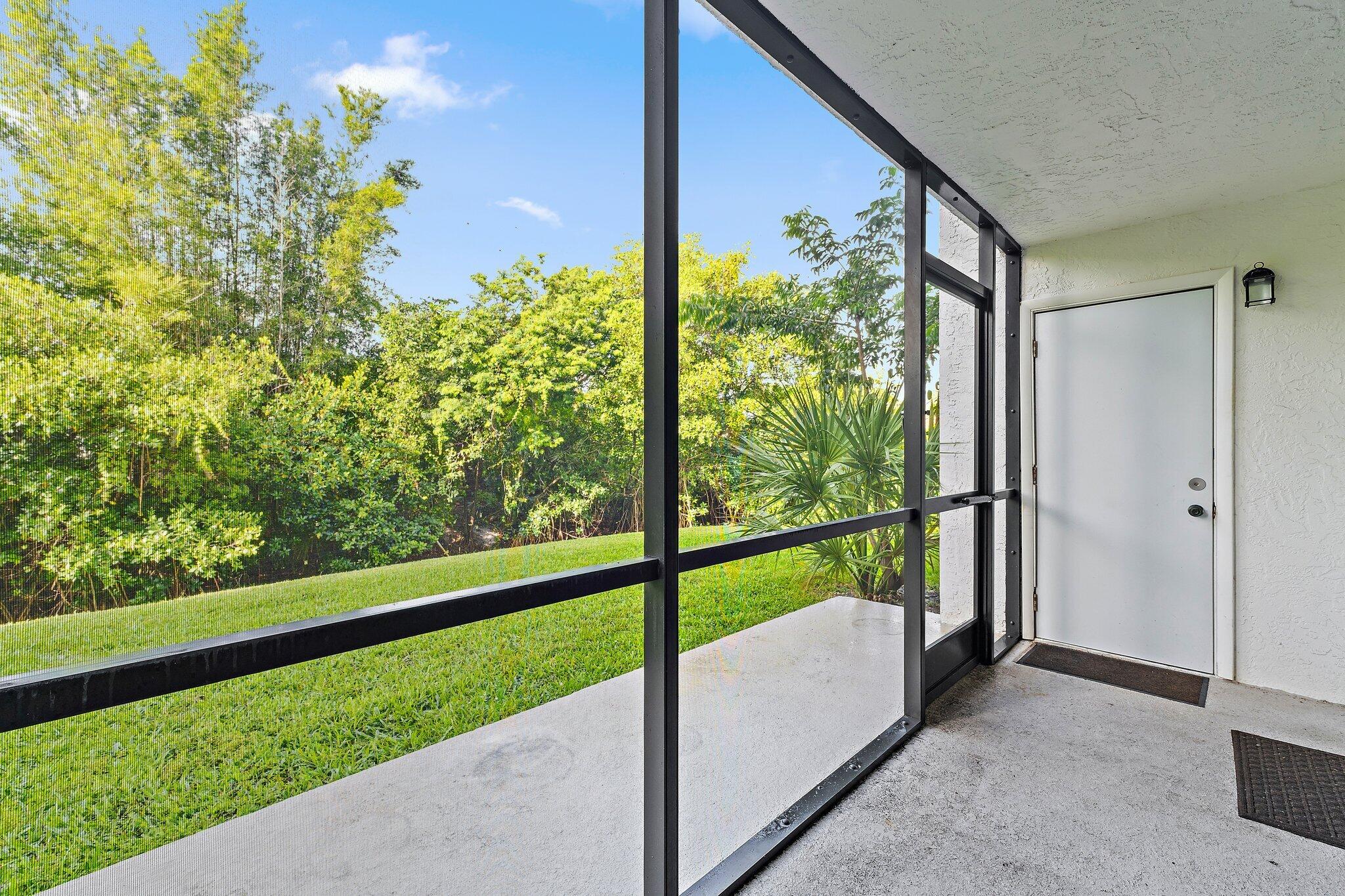 1605 South U Highway, Unit F 106 Jupiter, FL 33477 - Photo 21 of 43 a view of a porch and a yard