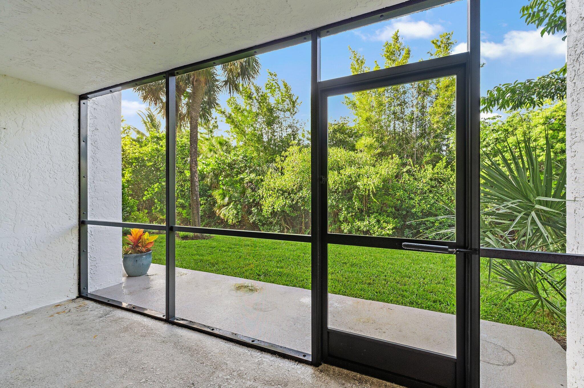1605 South U Highway, Unit F 106 Jupiter, FL 33477 - Photo 22 of 43 a view of an porch with furniture and garden view