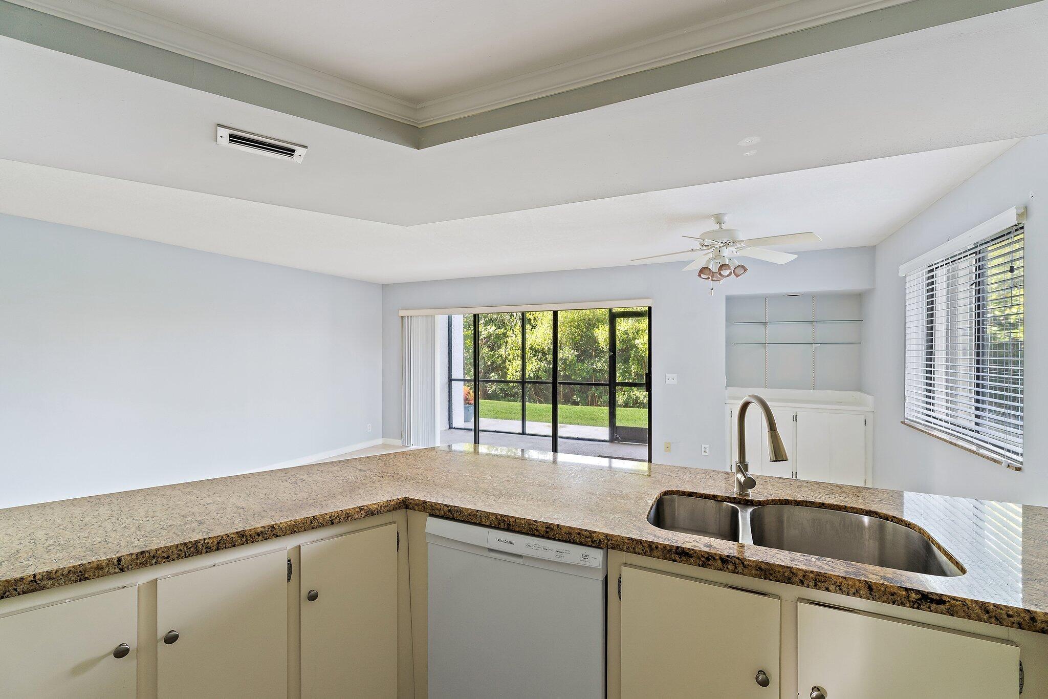 1605 South U Highway, Unit F 106 Jupiter, FL 33477 - Photo 31 of 43 a kitchen with a sink and cabinets