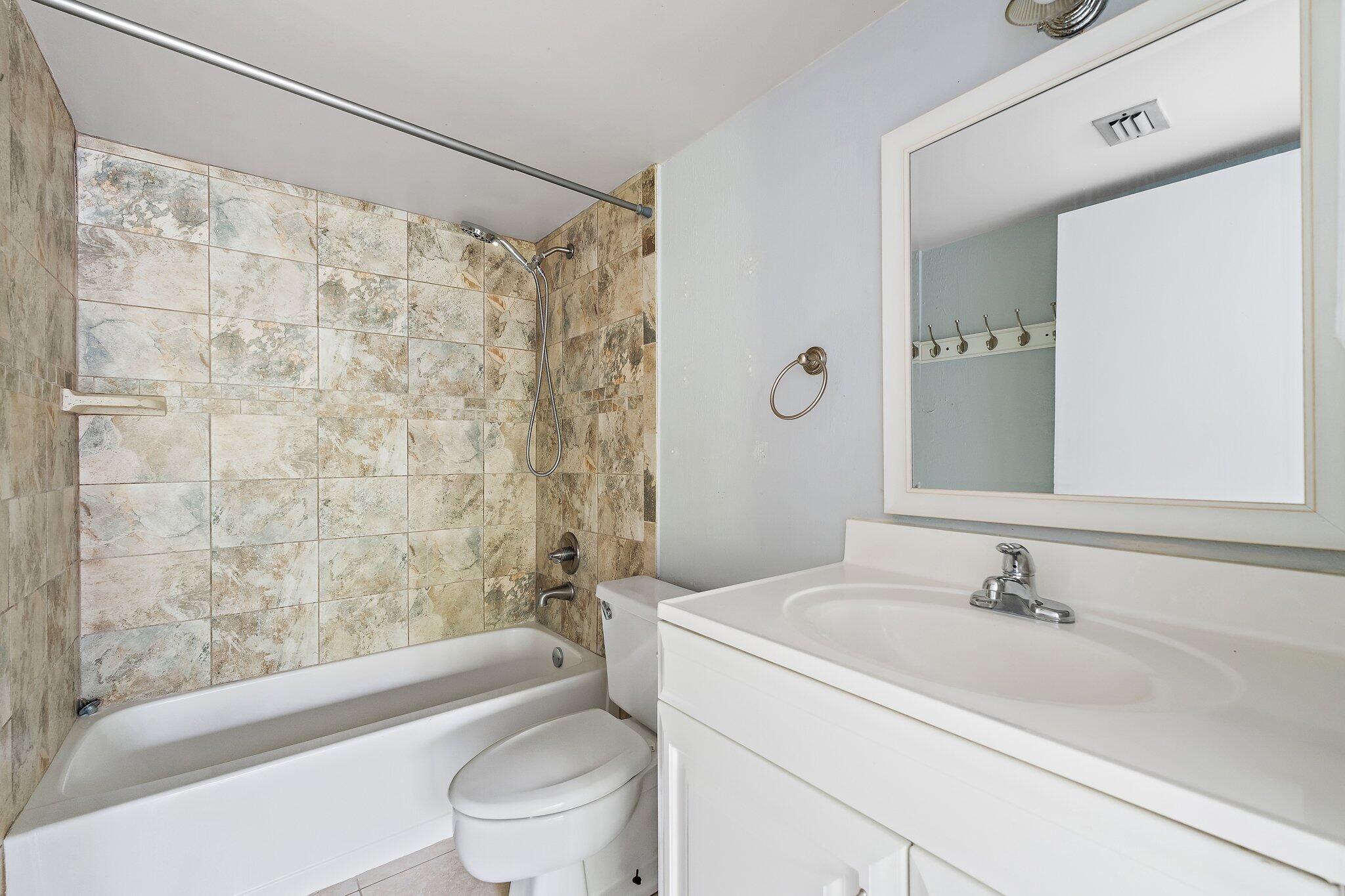 1605 South U Highway, Unit F 106 Jupiter, FL 33477 - Photo 39 of 43 a bathroom with a sink toilet and shower