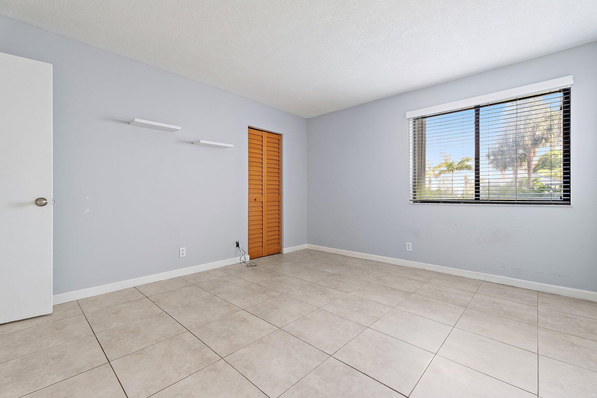 1605 South U Highway, Unit F 106 Jupiter, FL 33477 - Photo 41 of 43 a view of an empty room with a window
