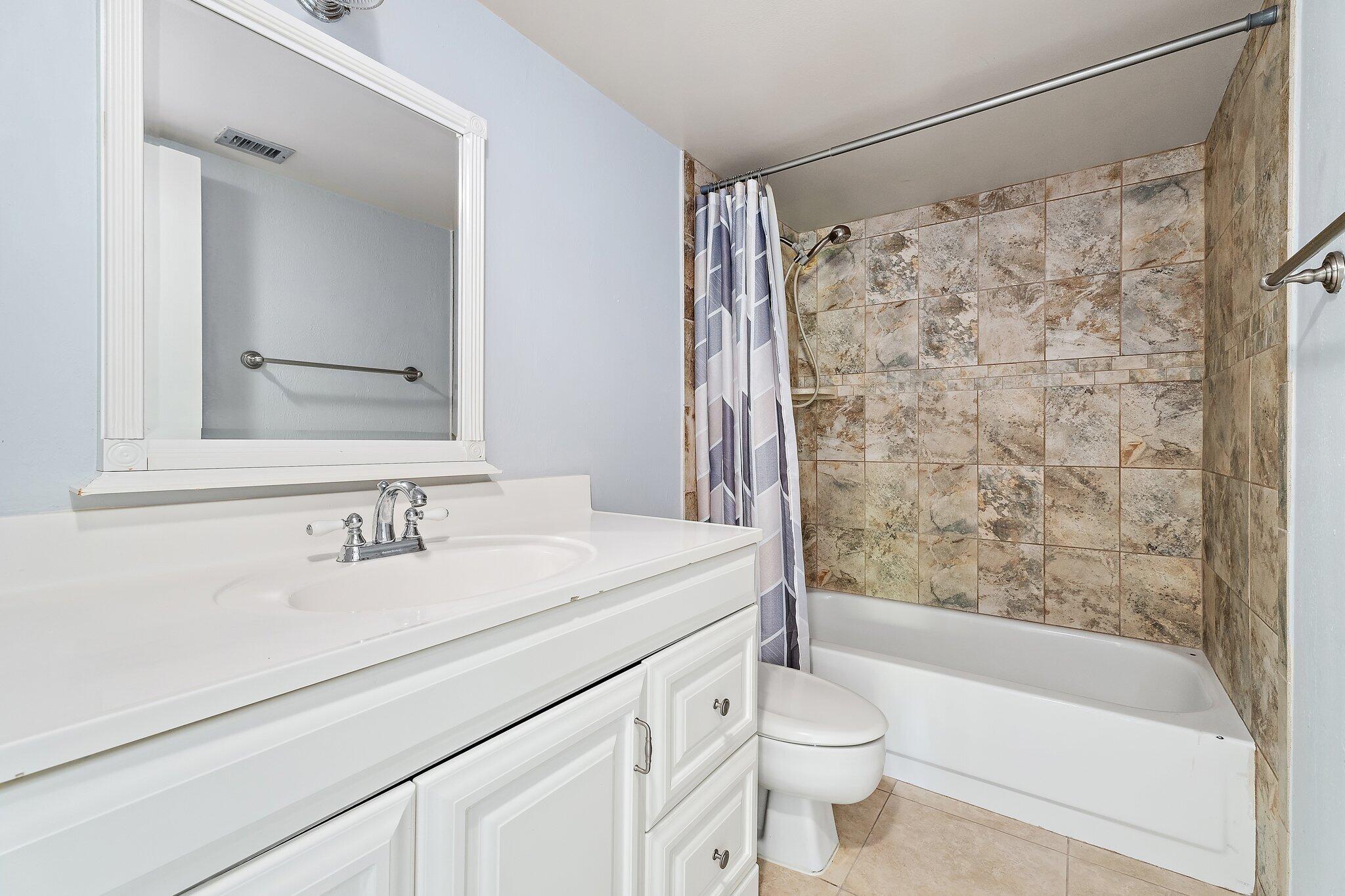 1605 South U Highway, Unit F 106 Jupiter, FL 33477 - Photo 43 of 43 a bathroom with a sink a toilet and shower