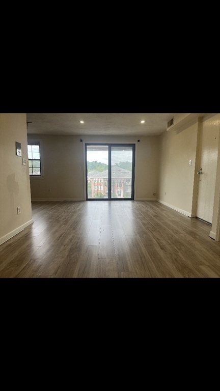 360 Neponset Street, Unit 605 Canton, MA 02021 - Photo 12 of 21 a view of an empty room with wooden floor and a window
