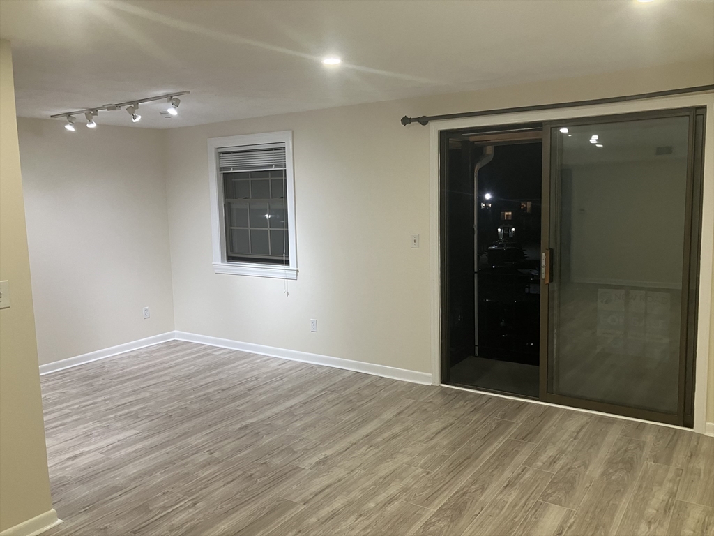 360 Neponset Street, Unit 605 Canton, MA 02021 - Photo 4 of 21 a view of an empty room with wooden floor and a bathroom