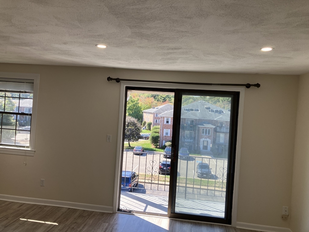 360 Neponset Street, Unit 605 Canton, MA 02021 - Photo 9 of 21 a view of an entryway with wooden floor and garden