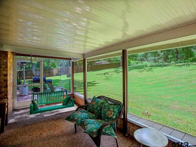 a view of a garden with chairs in patio