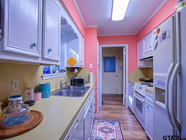 a kitchen with stainless steel appliances granite countertop a stove a sink and a refrigerator