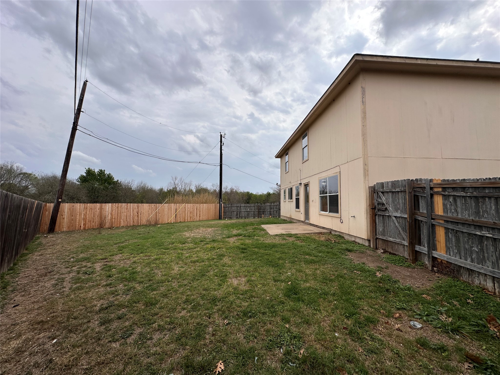 722 Lavaca Loop Elgin, TX 78621 - Photo 23 of 24 Fenced backyard with a patio