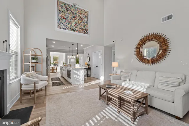 a living room with furniture a rug and a large window