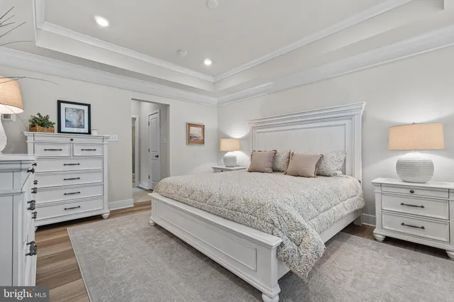 a large bed sitting in a bedroom and a dresser