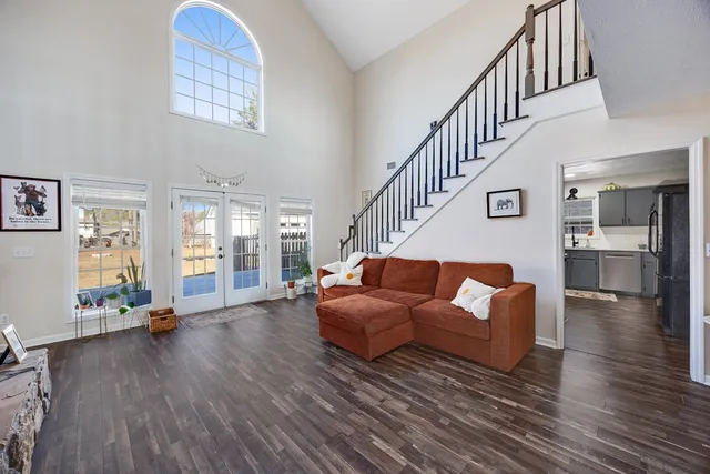 a bedroom with furniture window and wooden floor