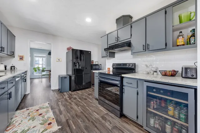 a kitchen with stainless steel appliances granite countertop a stove and a refrigerator