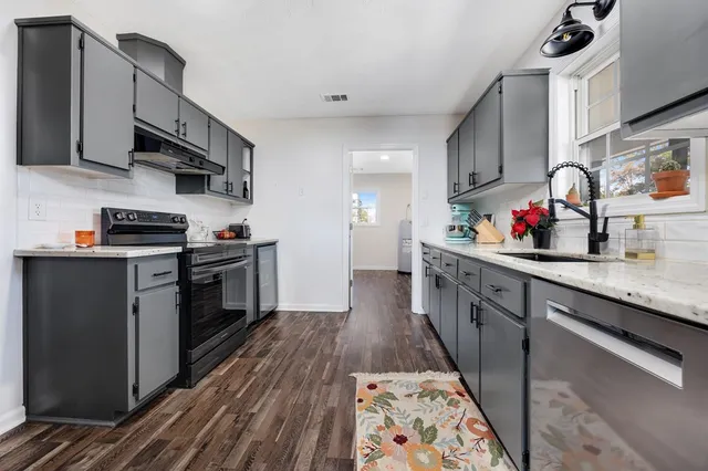 a kitchen with stainless steel appliances a refrigerator and a stove top oven