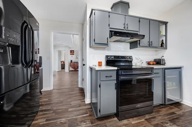 a kitchen with a sink cabinets and wooden floor
