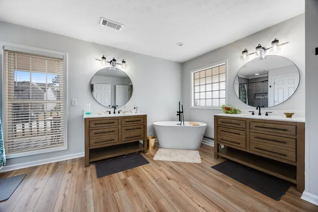 a kitchen with a sink cabinets and wooden floor