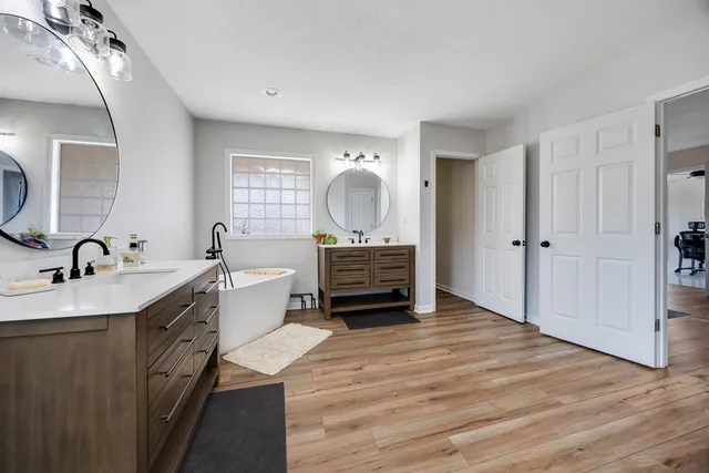 a bathroom with a toilet sink and mirror