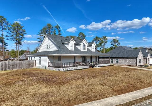 a view of house with outdoor space and sitting area