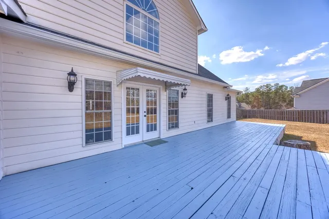 a view of a house with a big yard and large tree