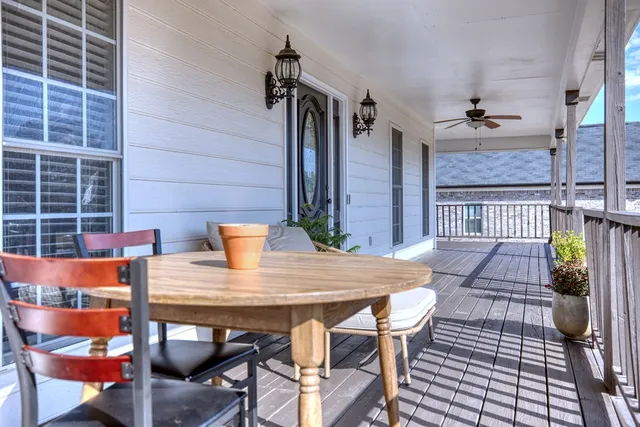 a view of a hallway with wooden floor and a potted plant