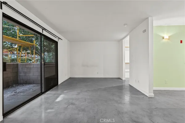 an empty room with sliding glass door