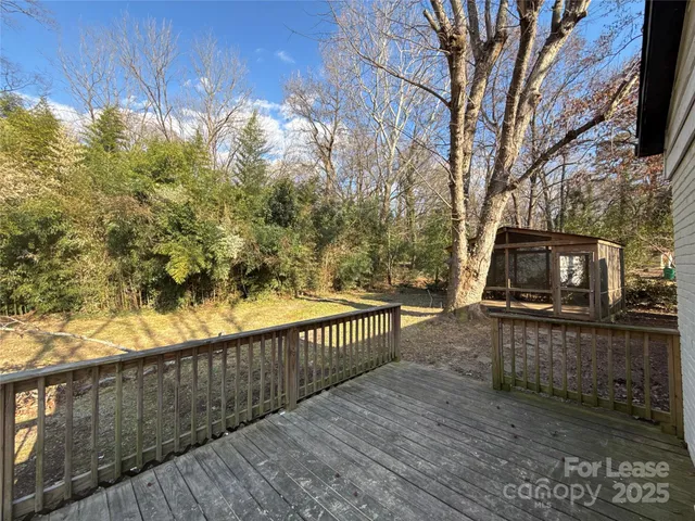 a view of a balcony with wooden floor and fence