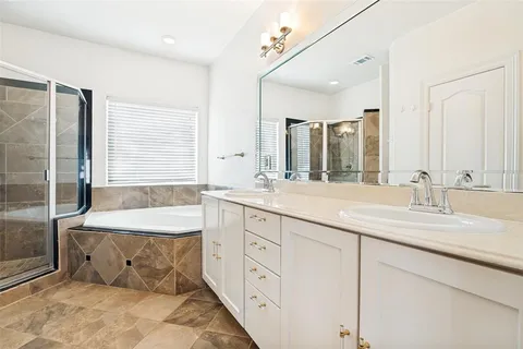 a bathroom with double vanity sink and a mirror