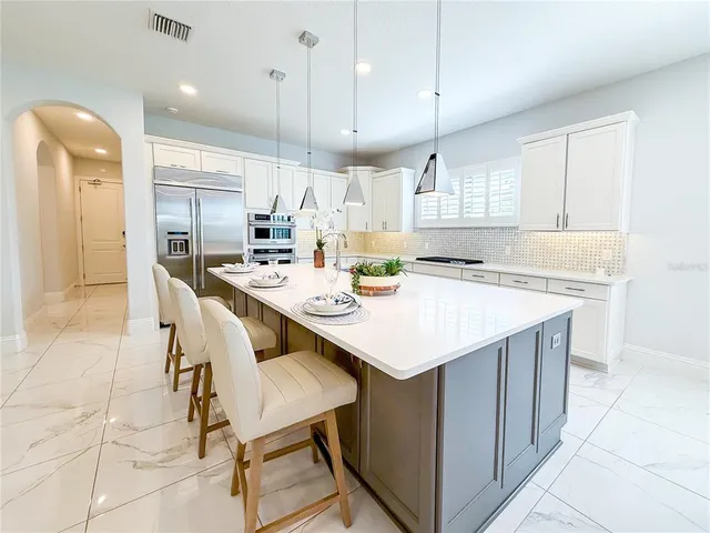 a living room with furniture and a kitchen view