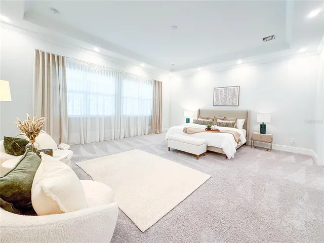 a spacious bathroom with a tub sink and mirror