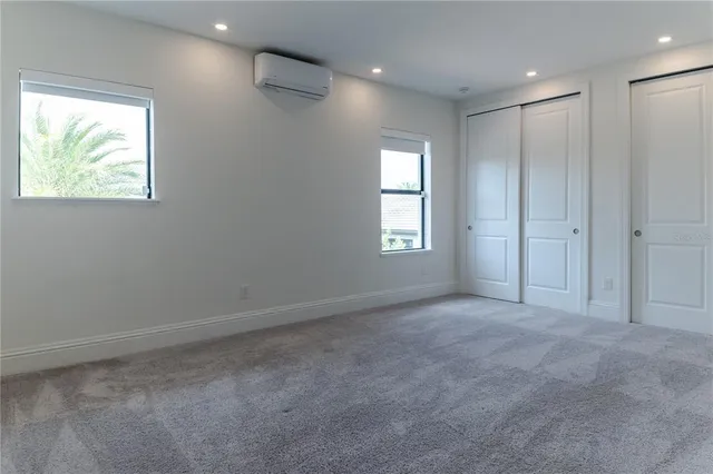 a large kitchen with stainless steel appliances a large counter top a stove a sink and a refrigerator