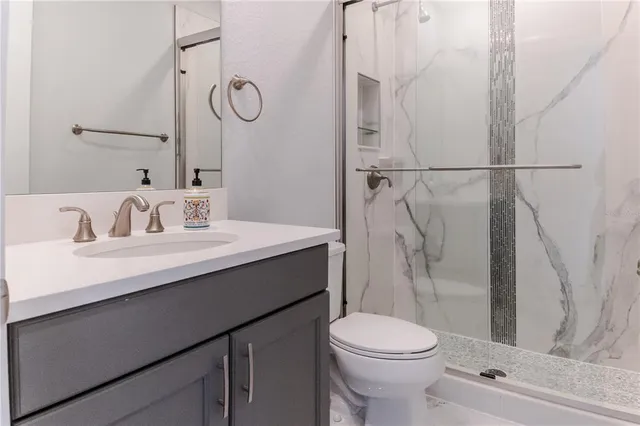 a view of a kitchen with a sink and a refrigerator