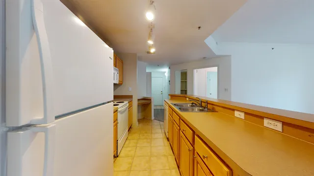 a view of a kitchen with a sink and wooden floor