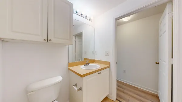 a bathroom with a granite countertop toilet and a bathtub