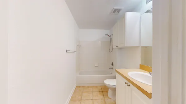 front view of a house with a yard and potted plants