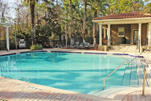 a swimming pool with outdoor seating and yard