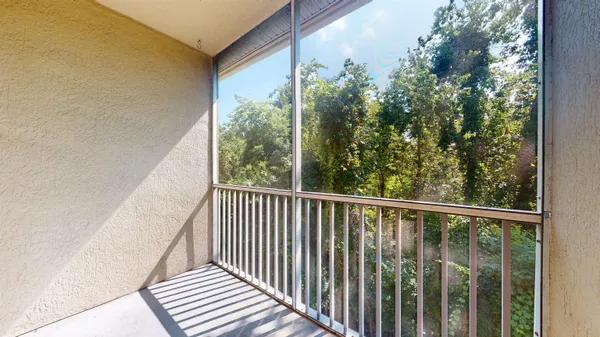 a view of a balcony with wooden floor